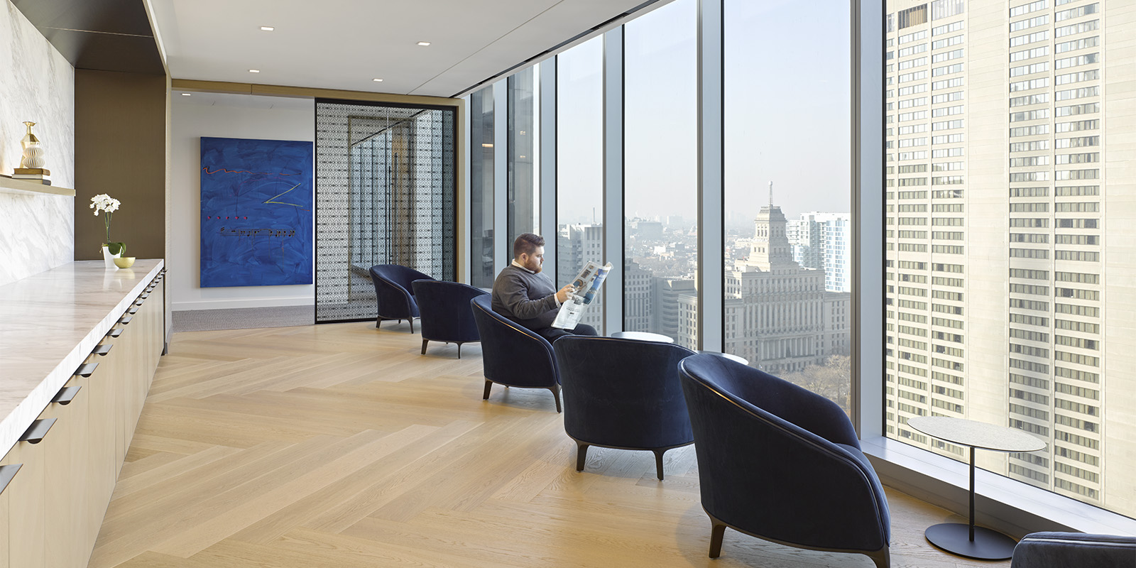 OMERS office seating area with upholstered chairs and large windows