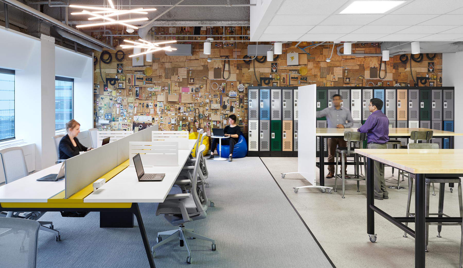 AVIVA Digital Garage workstations with lockers on back wall and decorative wall covered in craft supplies