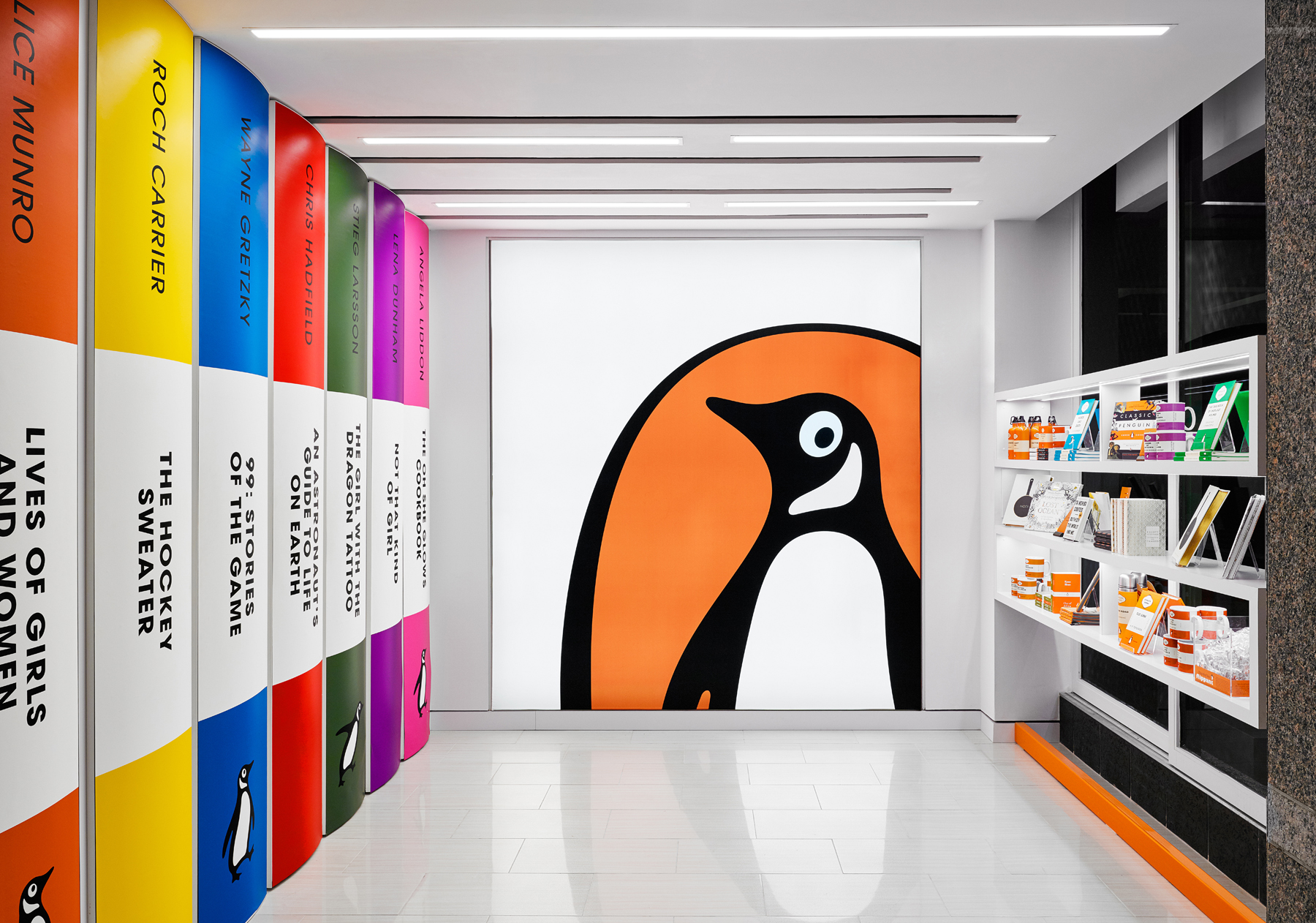 Penguin Shop with large scale Penguin logo on wall and pullout shelves printed with Penguin book spines