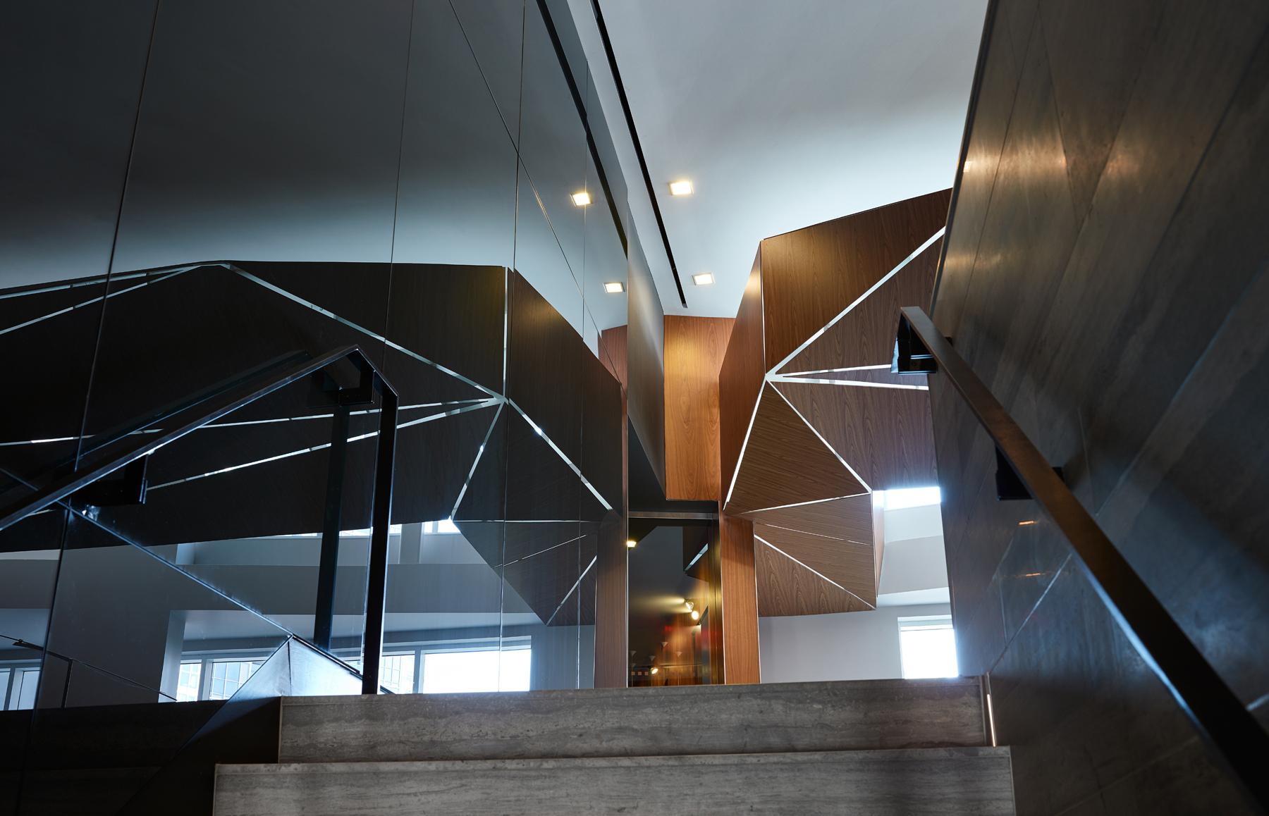 Concord Quartz, detail of staircase with glossy black walls and strips of lighting that form geometric pattern