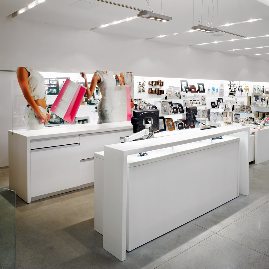 Umbra Toronto gallery, with white desk and shelves displaying picture frames