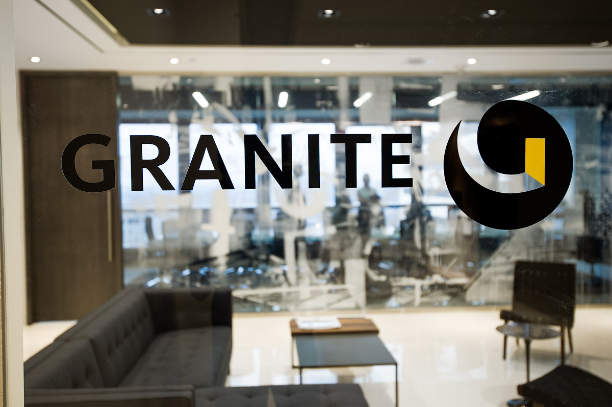 Granite Toronto glass wall with logo in black and yellow